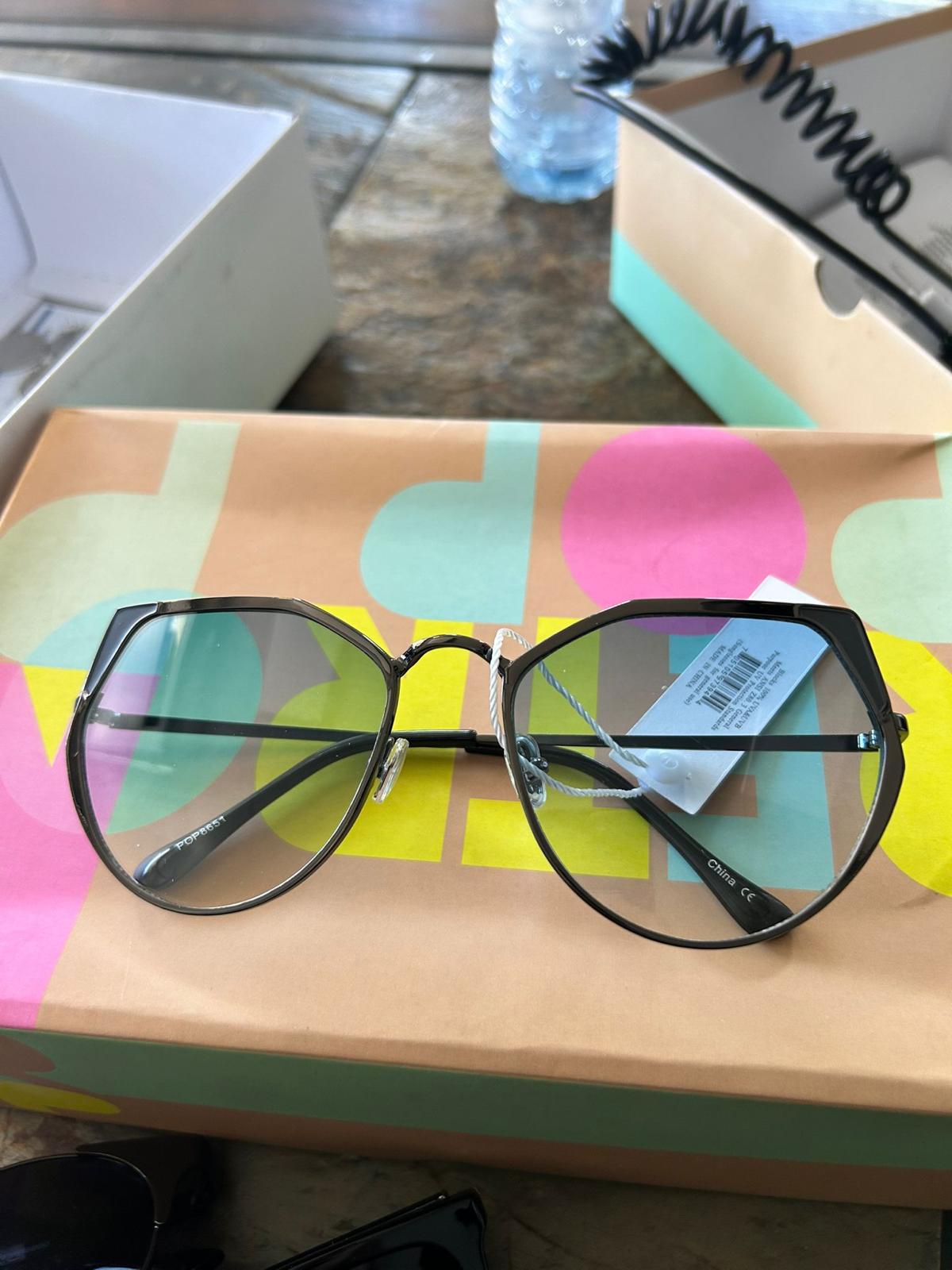 Geometric black frame sunglasses with clear blue lenses