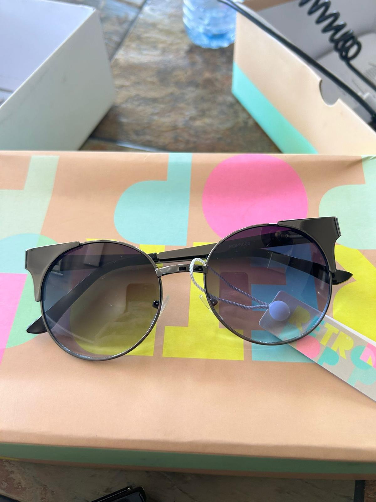 Clubmaster style sunglasses with dark lenses